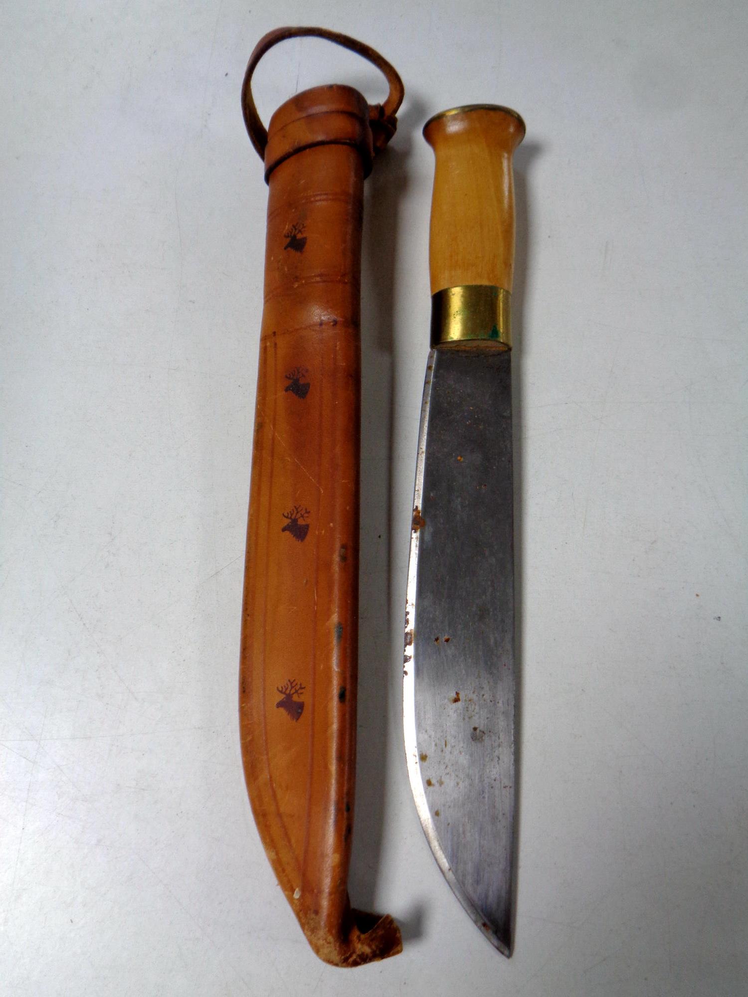A Swiss hunting knife in leather sheath