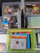 Eight plastic storage boxes with lids containing assorted books
