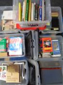 Eight plastic storage boxes with lids containing assorted books