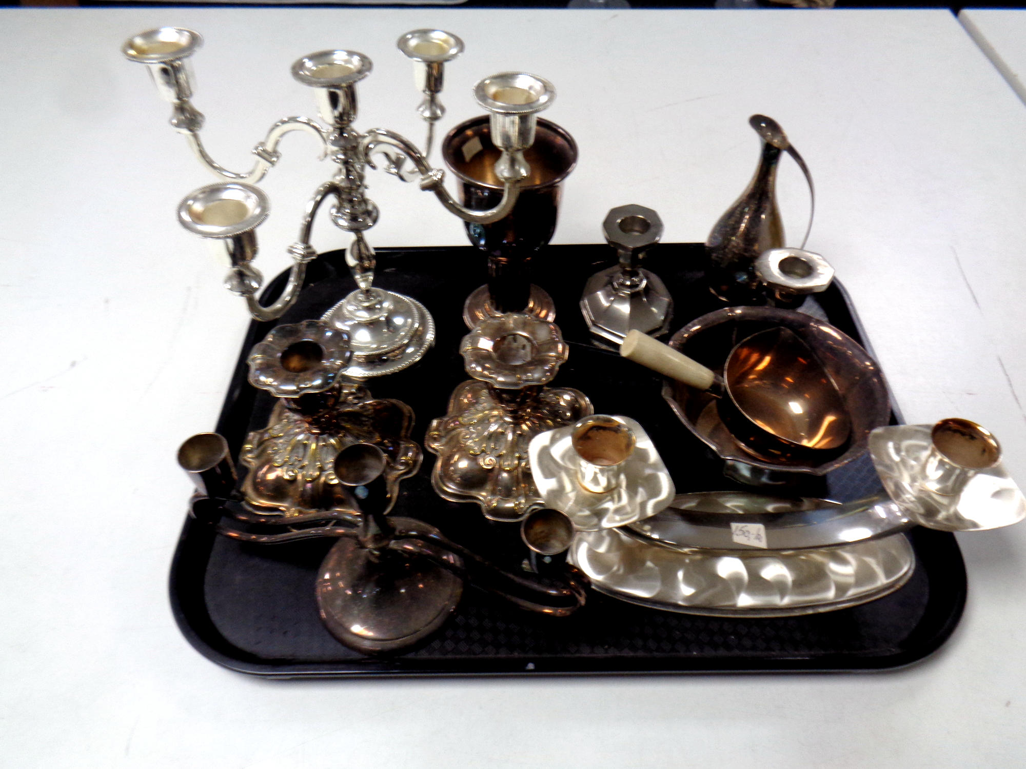 A tray of antique and later plated wares : candlesticks,