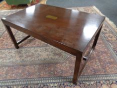 A refectory coffee table in a mahogany finish with a brass inset plaque