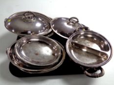 A tray of a quantity of antique plated entree dishes with covers.