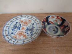 An antique Imari scalloped edge bowl together with a further glazed wall plate.