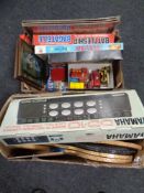 Two boxes of die cast cars, vintage board games, assorted sports rackets,