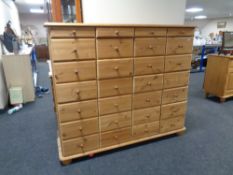 A bank of twenty eight pine drawers