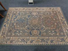 A machine made floral rug on green ground,