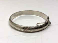 A sterling silver bangle with safety chain