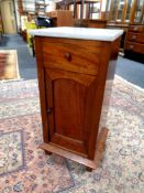 An early 20th century marble topped pot cupboard