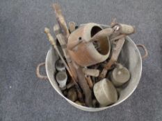 An aluminium twin handled cooking pot containing antique metal wares,