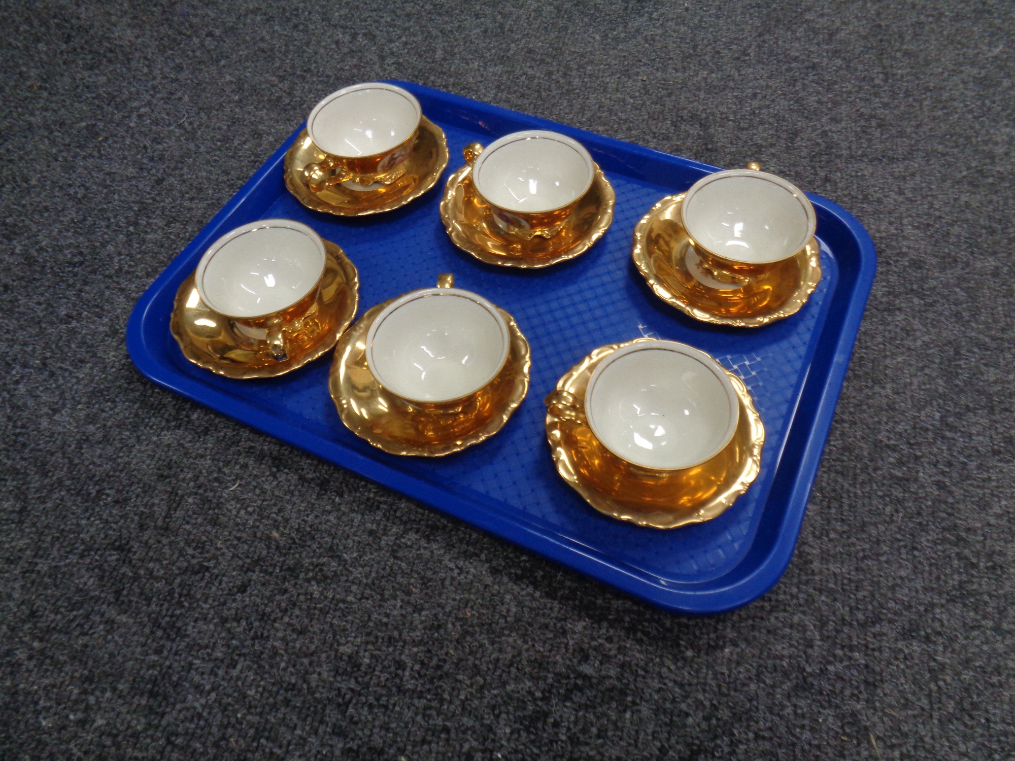 A set of six Bavarian gilded tea cups with saucers