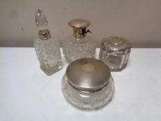 Four cut glass silver topped and rimmed perfume bottles,