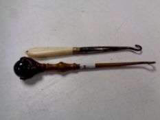 A Victorian claw and ball handled button hook and one further (2)