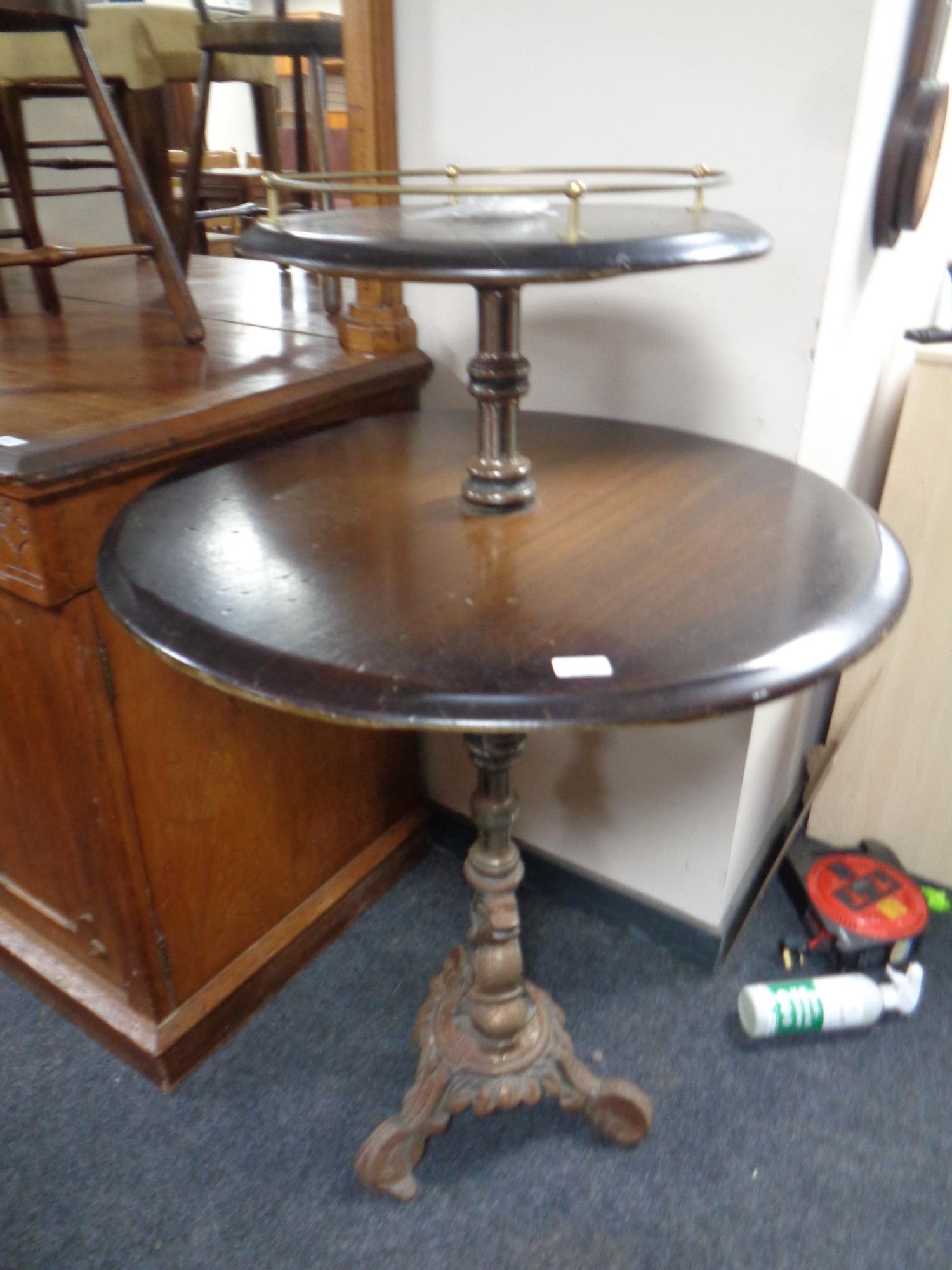 A two tier poser bar table on a cast iron base