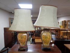 A pair of contemporary ceramic floral patterned table lamps with shades