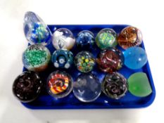 A tray containing 15 assorted glass paperweights to include Caithness,