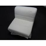 A bed chair with a white loose cover