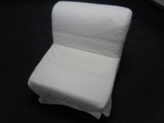 A bed chair with a white loose cover