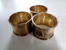 A set of three Birmingham silver napkin rings bearing the HMS Sussex badge