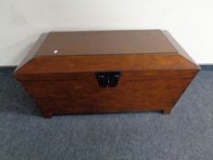 A contemporary sarcophagus shaped blanket chest