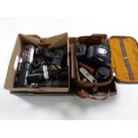 A box containing Cosina and Colora cameras together with assorted lenses and accessories