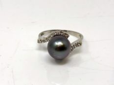An 18ct white gold pearl and diamond ring, size P.