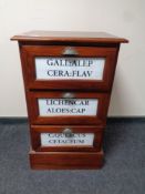 A reproduction three drawer chest with advertising decoration