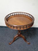 A mahogany pedestal wine table with gallery on claw and ball feet