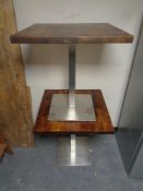 A pair of pine topped metal based cafe tables