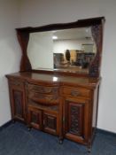 An Edwardian mahogany Arts and Crafts bow fronted mirror backed sideboard