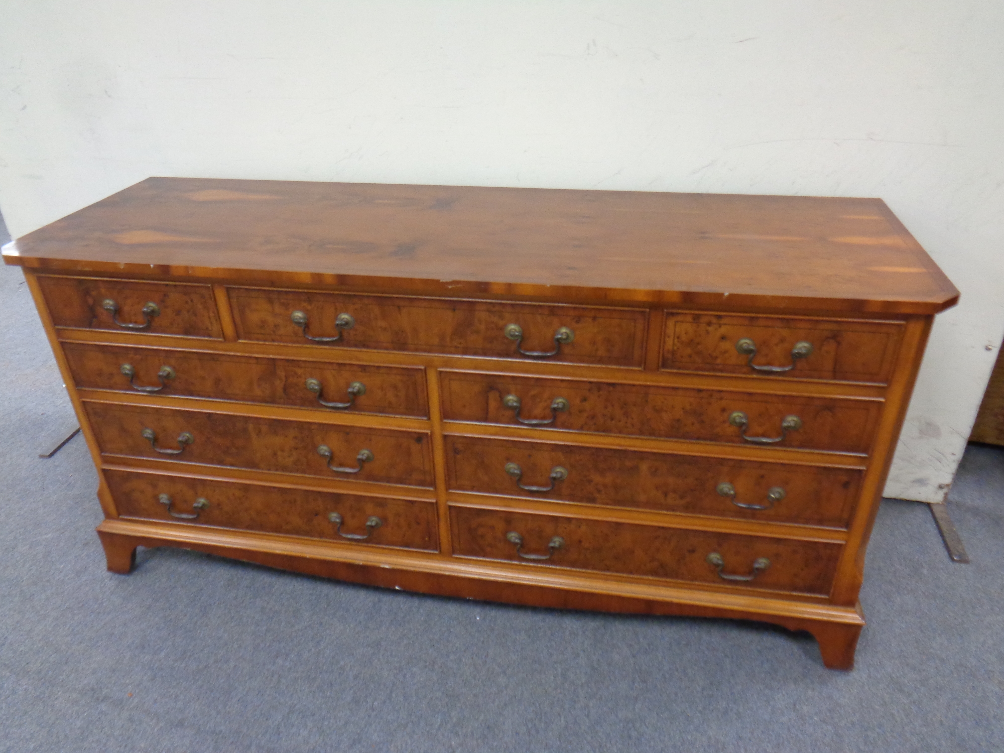 An inlaid yew wood nine drawer chest