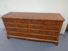 An inlaid yew wood nine drawer chest