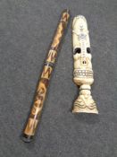 A contemporary wooden carving and a tourist digeridoo