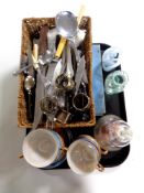 A tray containing miscellaneous to include plated napkin rings, assorted cutlery, bread knives,