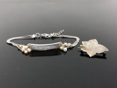 An old brooch and silver bracelet
