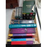 A wicker basket containing a Lord of the Rings and The Hobbit paperback box set, audio CDs,