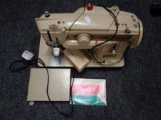 A 20th century Singer electric sewing machine with accessories