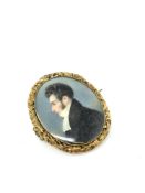 An early 19th century memoriam locket with portrait miniature and lock of hair in gold frame