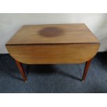 A 19th century mahogany drop leaf table on brass casters