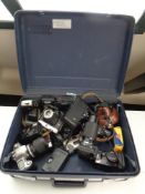 A Delsey luggage case containing a large quantity of assorted vintage and later cameras to include