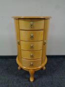 A Mele and Company jewellery chest on raised legs