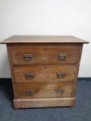 An Edwardian oak three drawer chest