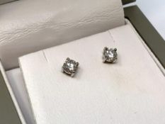 A good pair of 18ct white gold solitaire diamond earrings, 0.9 carat total.