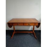 A yew wood drop leaf sofa table fitted two drawers