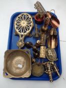 A tray containing antique and later brass ware to include trivet, cannon ornaments,