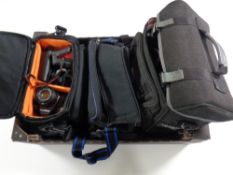 Three camera bags containing cameras by Praktica, lenses, accessories, HD hand held video camera,