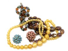 A collection of hard stone beads and brooches.