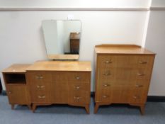 A 20th century teak three piece bedroom suite comprising of three drawer dressing chest,