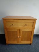 A contemporary pine double door cabinet fitted a drawer