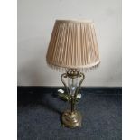 A decorative brass and cut glass table lamp with beaded shade