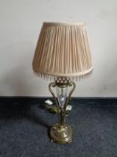 A decorative brass and cut glass table lamp with beaded shade